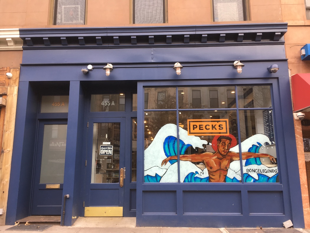 A Black Artstory month mural by Steven Mosley decorates the window of Peck's on Myrtle Avenue.